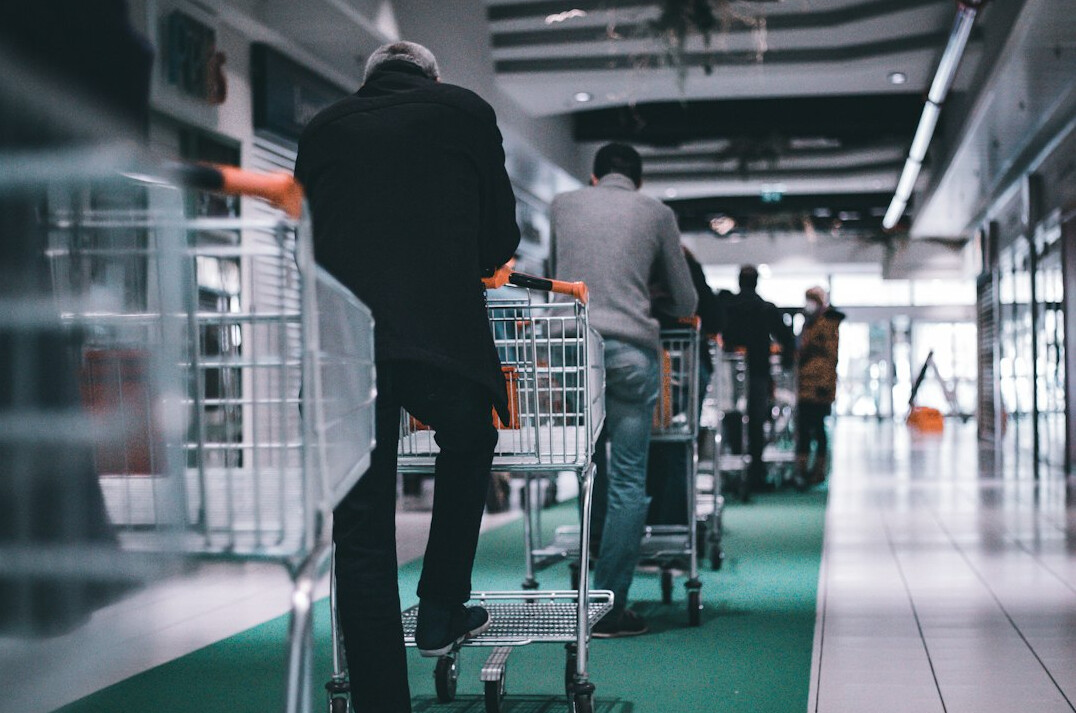 detective walking through supermarket