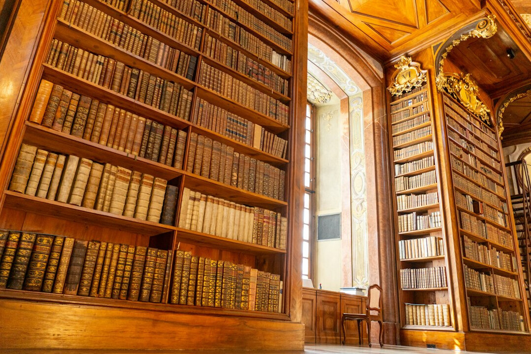 Atmospheric old library with tall wooden shelves full of books