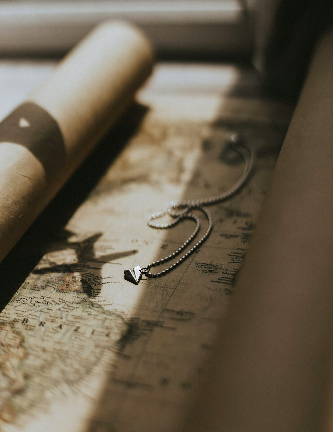 Old paper map spread on a table with a compass