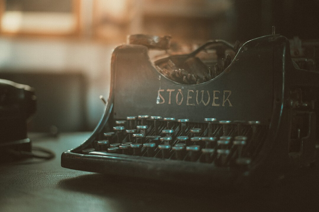 Vintage typewriter with a sheet of paper on a desk
